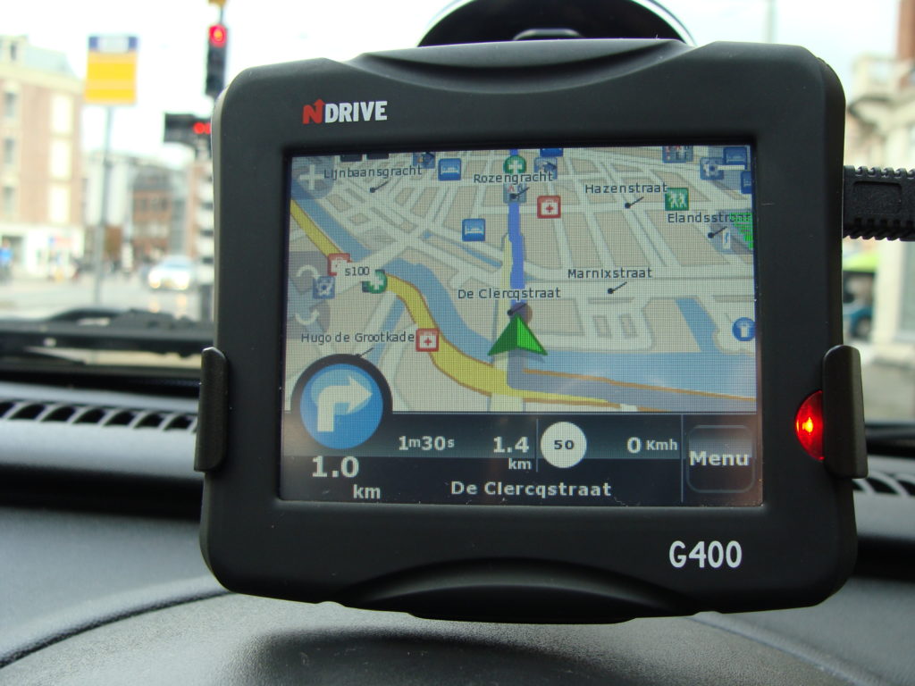 A GPS map unit on the dashboard of a car