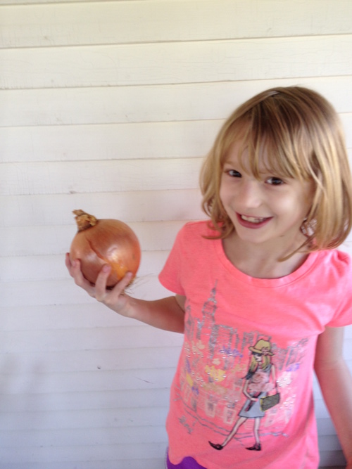 Tabitha holding a large onion