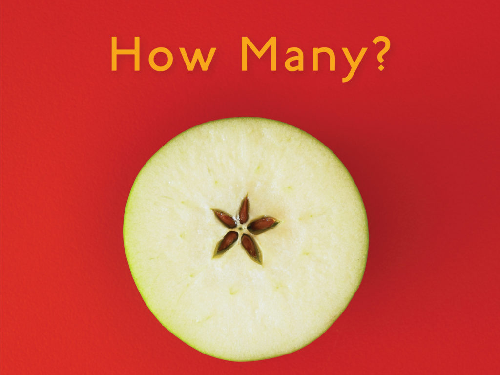 Book cover for How Many? A counting book. An apple is sliced horizontally, revealing a 5-pointed star of seed capsules.