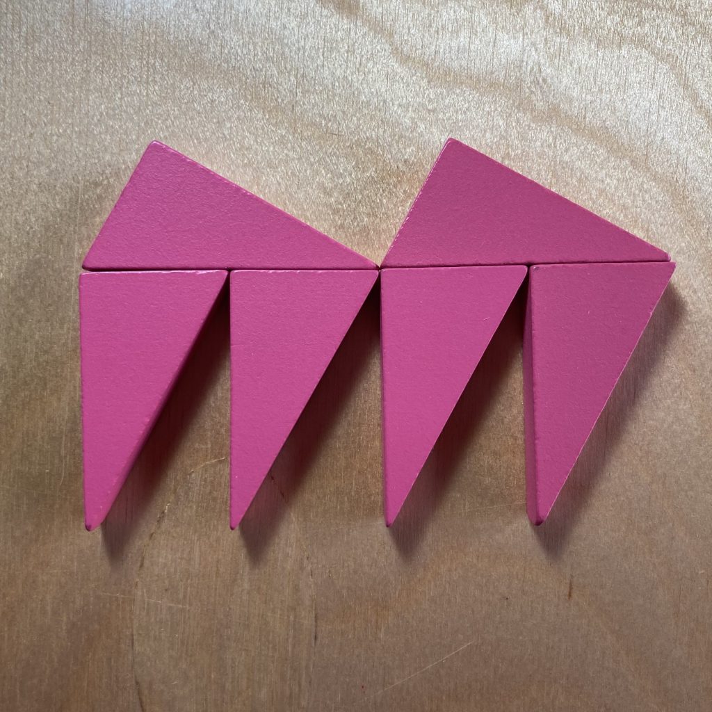 Two pink right triangles on top, their hypotenuses lined up against the short sides of four identical pink triangles beneath, demonstrating that two of the hypotenuse lengths equal four of the short side lengths.