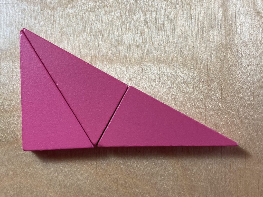 Three pink right triangles tiled to make a larger, similar triangle.