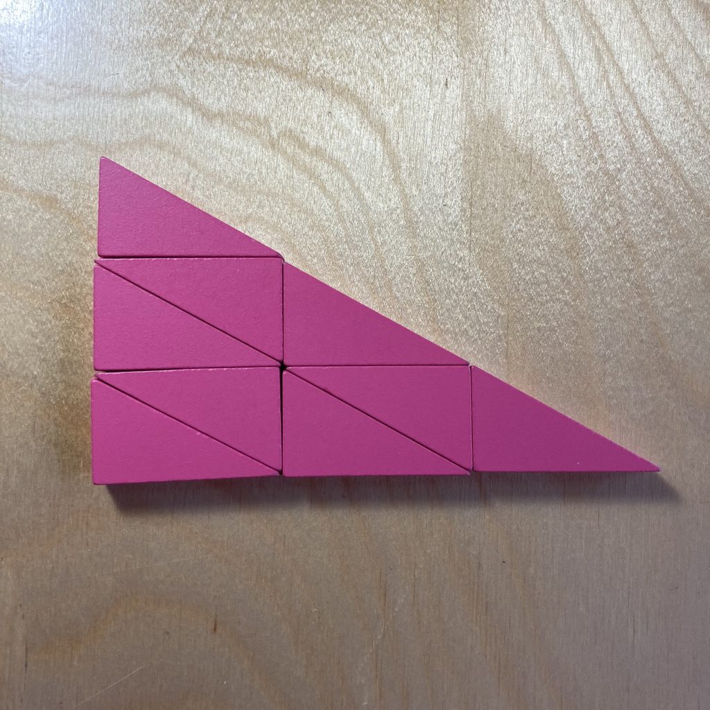 Nine pink right triangles tiled to make a larger, similar triangle.