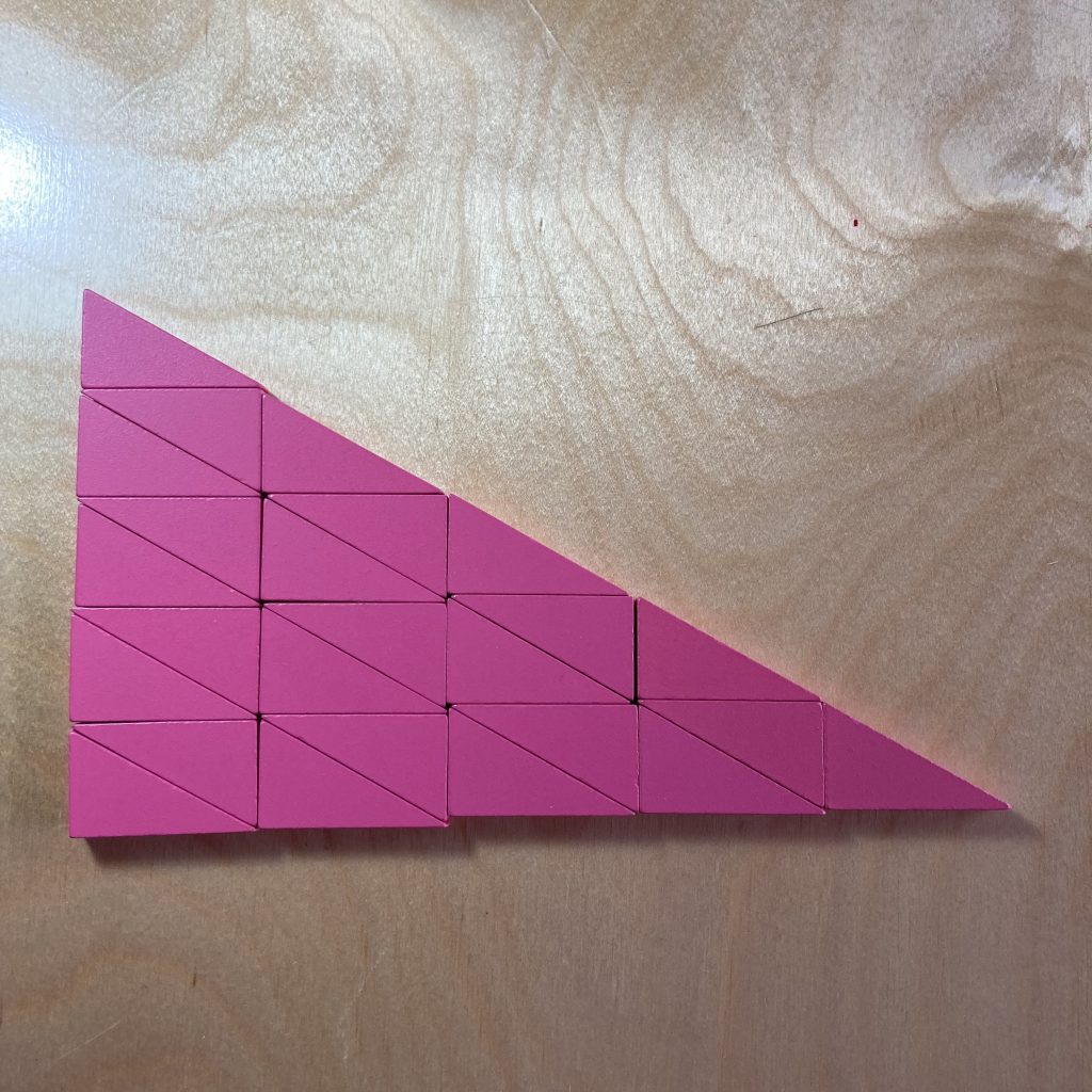 Twenty-five pink right triangles tiled to make a larger, similar triangle.