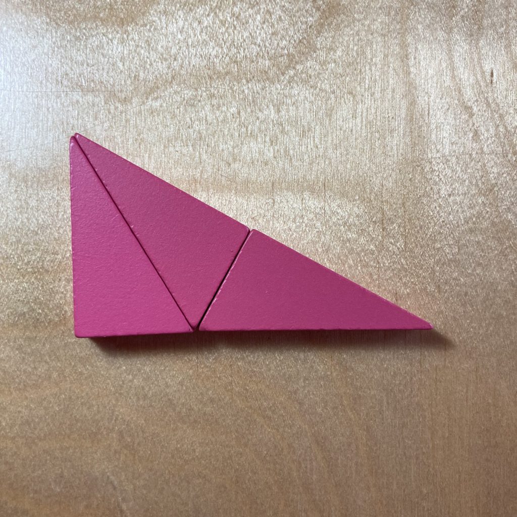 Three pink right triangles tiled to make a larger, similar triangle.