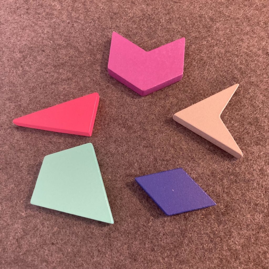 Five shapes: a pink concave equilateral hexagon, a pink 30-60-90 triangle, a teal kite, a blue diamond, and a gray dart.