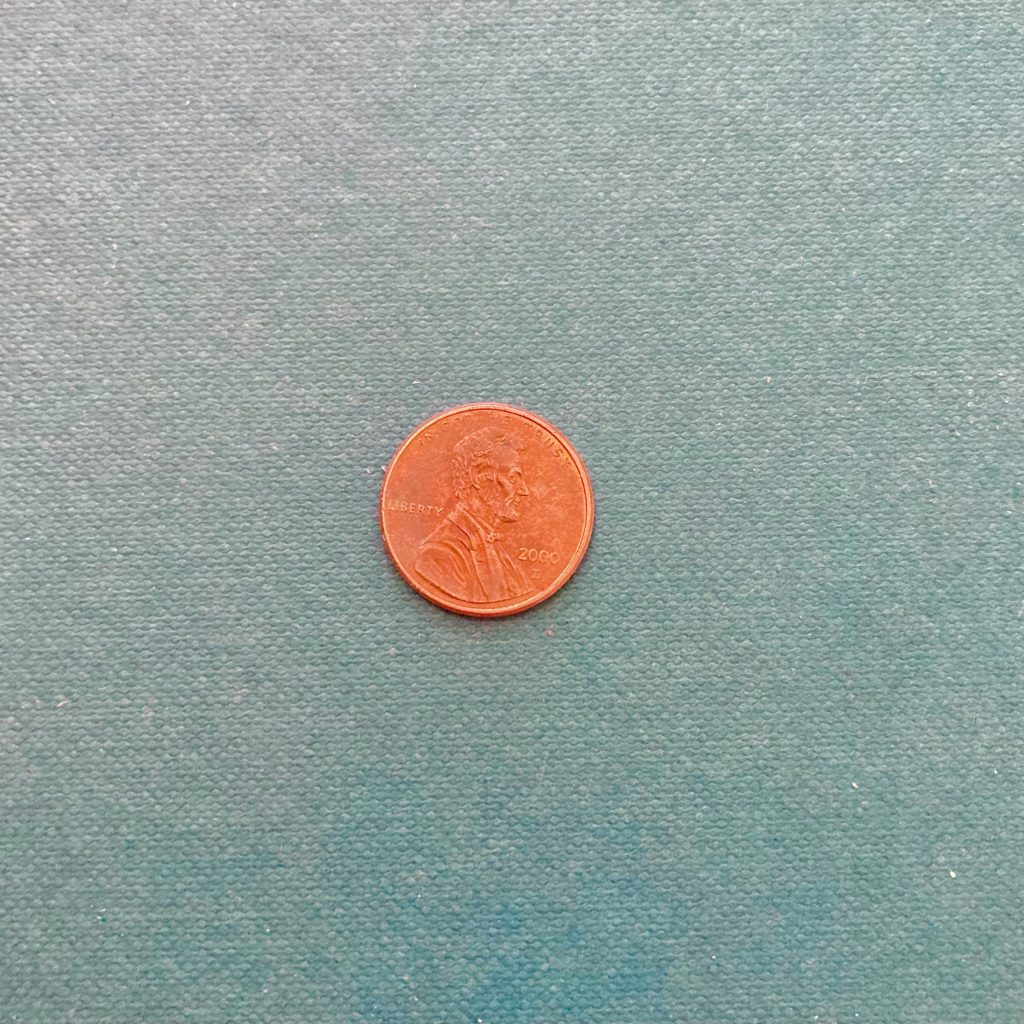 A penny on a blue background.
