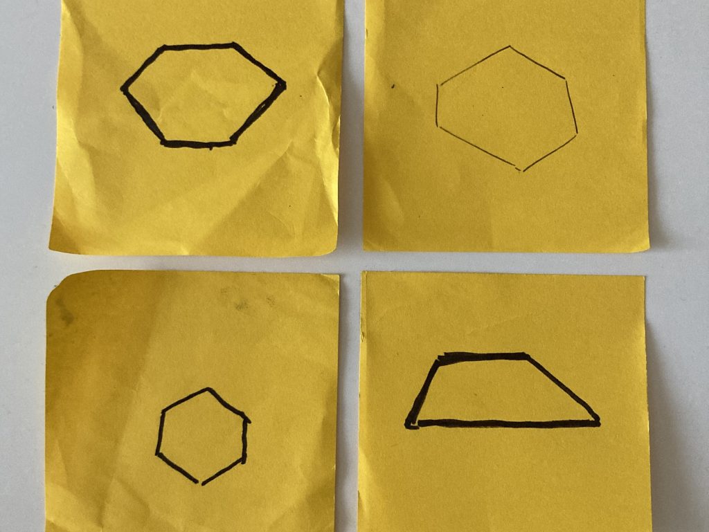 a two-by-two grid of yellow Post-its with hand-drawn shapes—three convex hexagons and a trapezoid